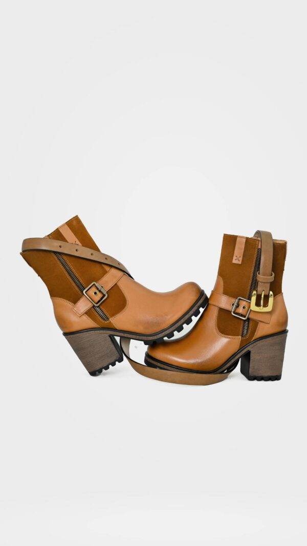 Elegant brown leather ankle boots with high heels and buckles, perfect for fashion-forward style.